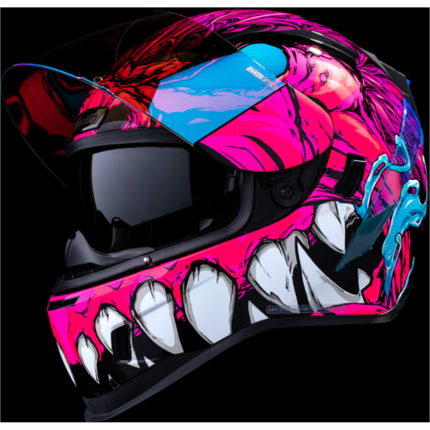 ICON Airform Manik'RR MIPS Helmet Pink - Front Left Side View with Dark Studio Background, Faceshield Raised, and Drop Down Sun Visor Lowered