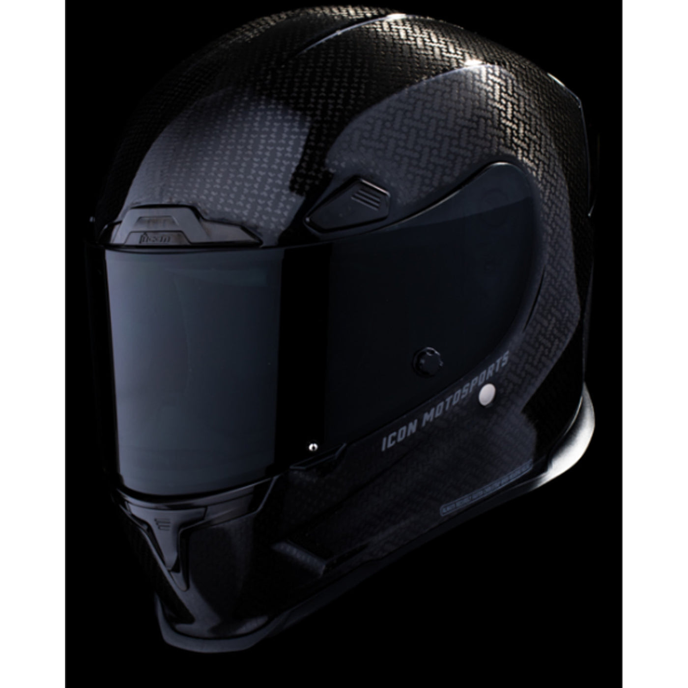 ICON Airframe Pro Carbon 4Tress Helmet Black - Front Left Side View with Dark Studio Background