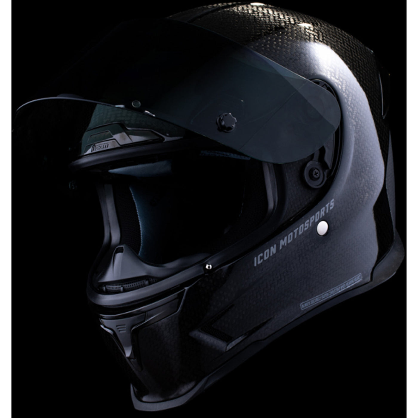 ICON Airframe Pro Carbon 4Tress Helmet Black - Front Left Side View with Dark Studio Background and Faceshield Raised