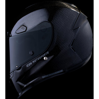 ICON Airframe Pro Carbon 4Tress Helmet Black - Left Side View with Dark Studio Background