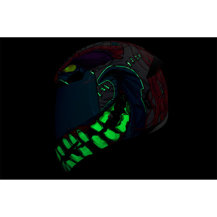 ICON Airframe Pro Krazy Klown 2 Helmet Pink - Left Side View with Dark Studio Background and Glow-in-the-Dark Graphics