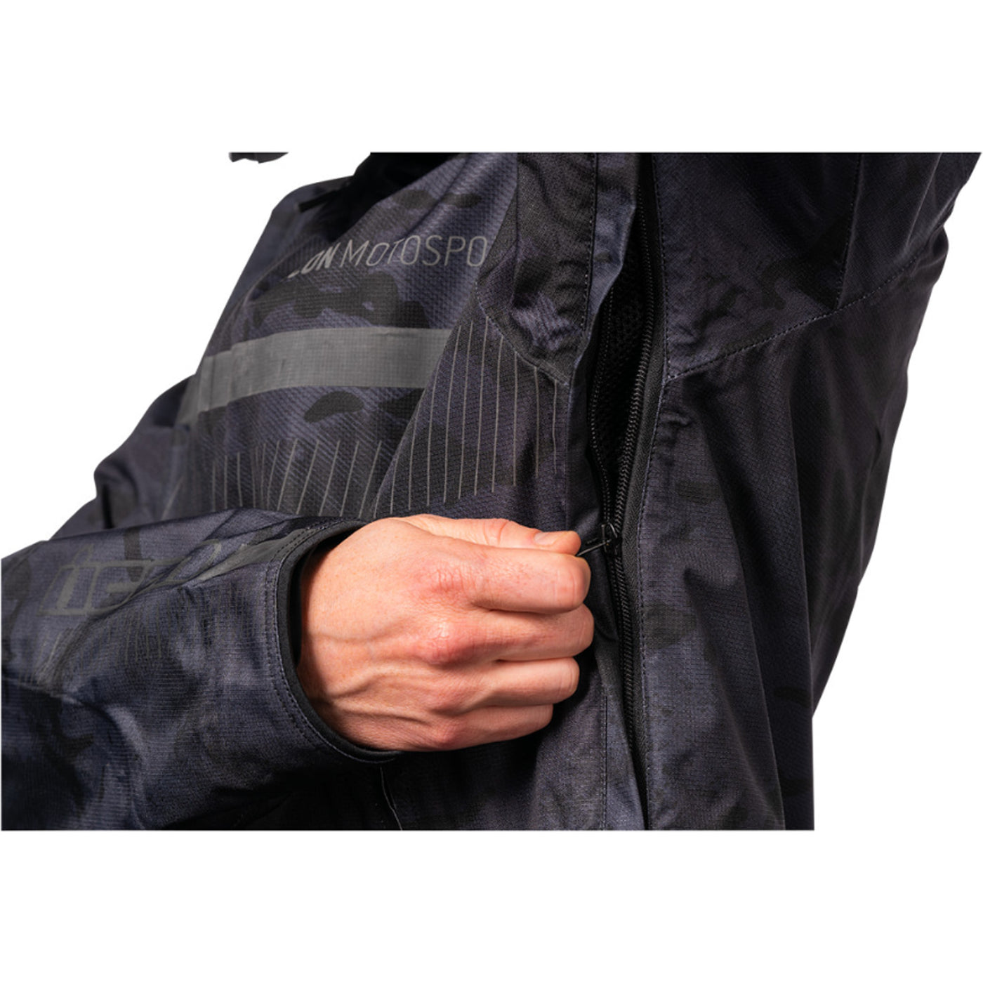 ICON PDX3 Jacket Dark Camo - Close-Up of Model Zipping Armpit Vent