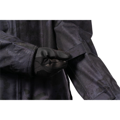 ICON PDX3 Jacket Dark Camo - Close-Up of Model Adjusting Arm Strap