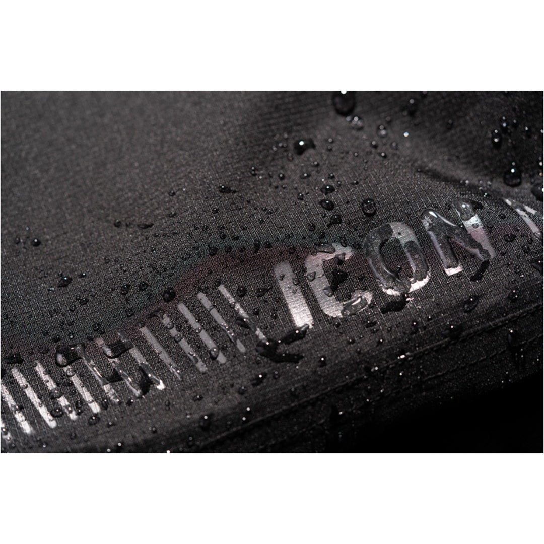 ICON PDX3 Overpant Black - Close-Up of Waterproof Material with Logo Graphic