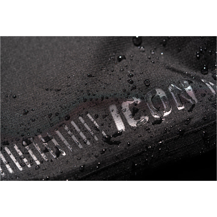 ICON PDX3 Overpant Black - Close-Up of Waterproof Material with Logo Graphic