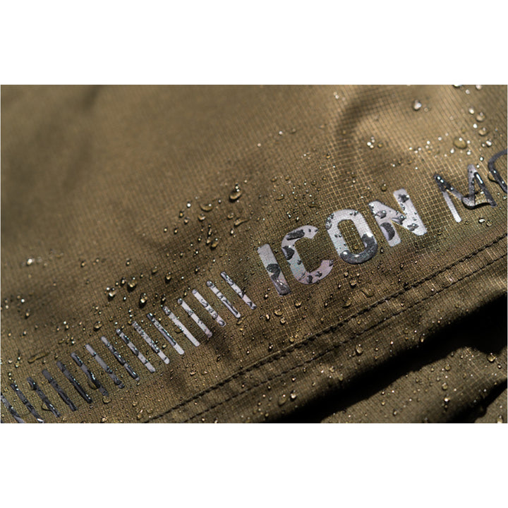 ICON PDX3 Overpant Olive - Close-Up of Waterproof Material with Logo Graphic