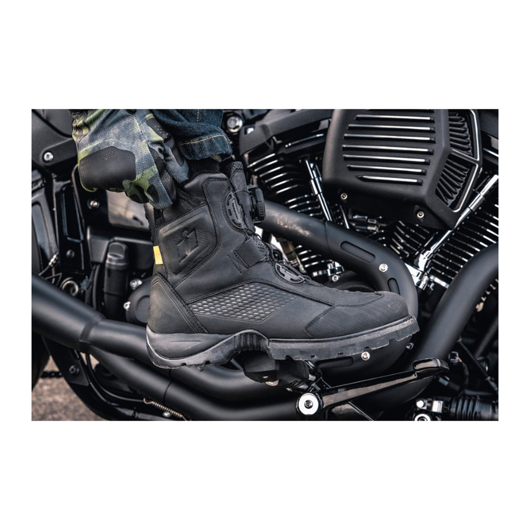 ICON Stormhawk Boots Black - Lifestyle Close-Up of Rider Reaching Down to Adjust Boot