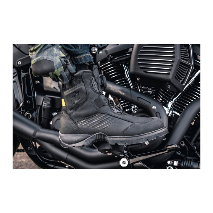 ICON Stormhawk Boots Black - Lifestyle Close-Up of Rider Reaching Down to Adjust Boot