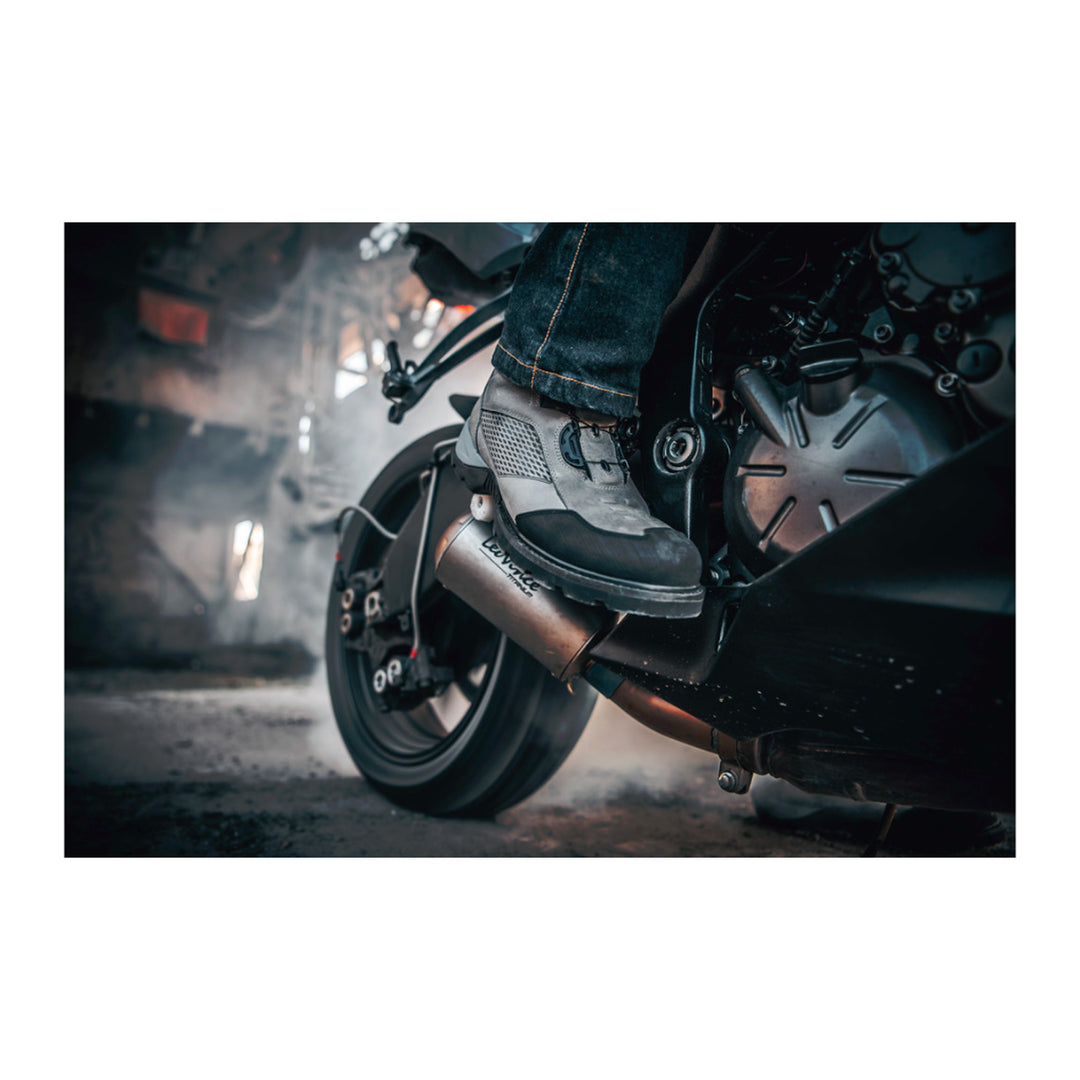 ICON Stormhawk Boots Gray - Lifestyle Close-Up of Rider Wearing Boots on Black Motorcycle