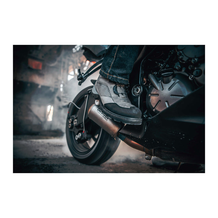 ICON Stormhawk Boots Gray - Lifestyle Close-Up of Rider Wearing Boots on Black Motorcycle