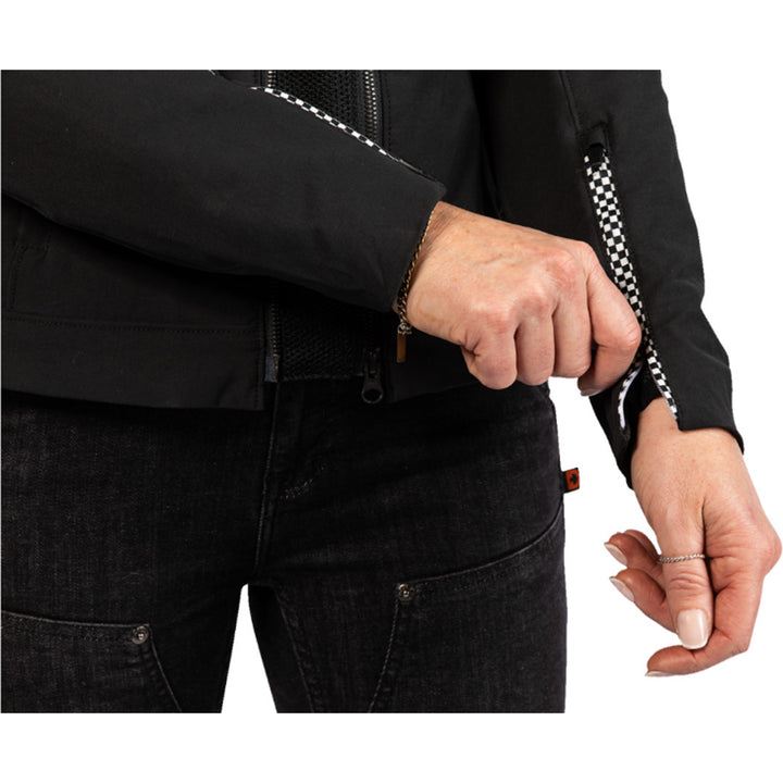 ICON Women's Hella 4 Jacket Black - Close-Up of Model Zipping Wrist Zipper