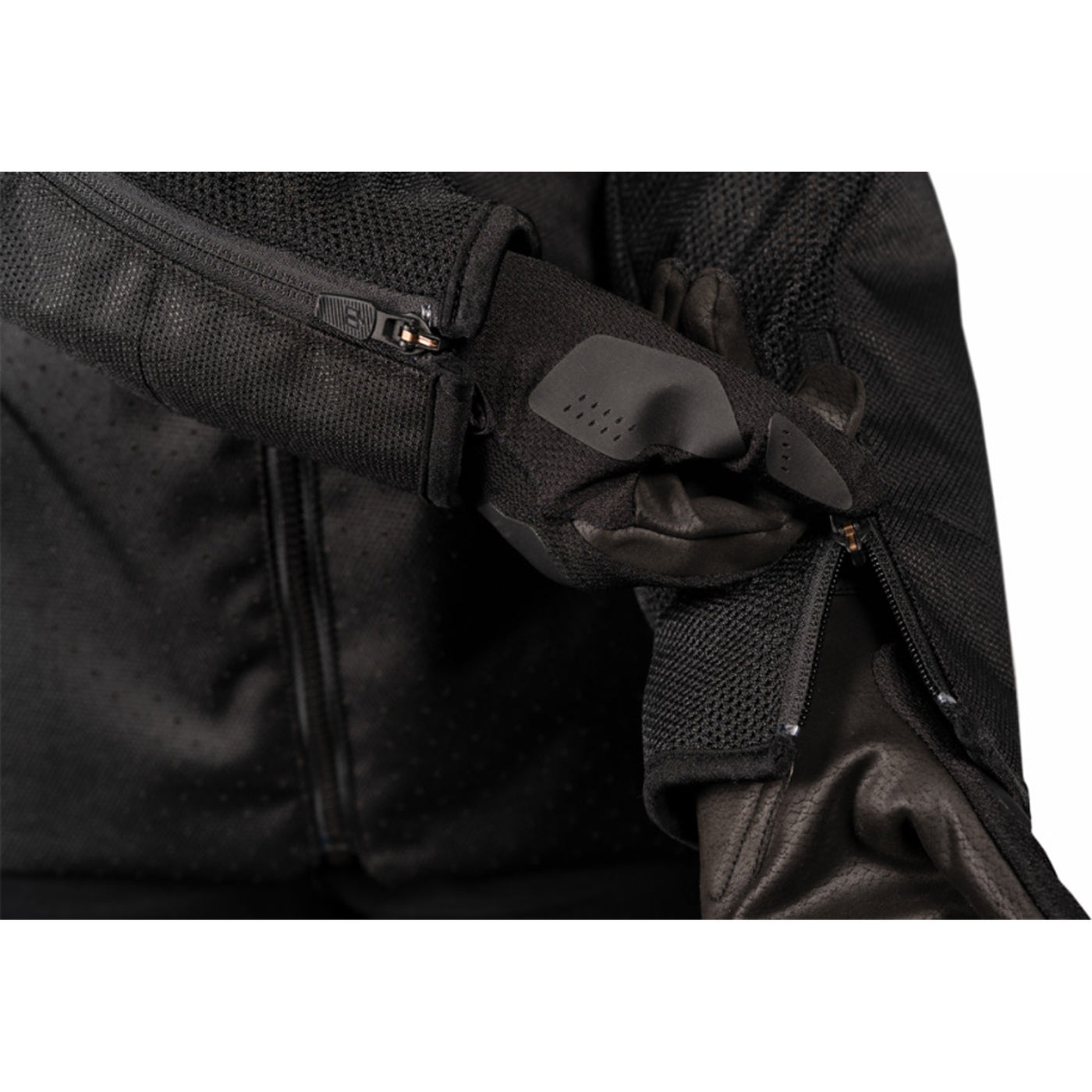 ICON Women's Hooligan CE Jacket Black - Close-Up of Model Zipping Wrist Zipper