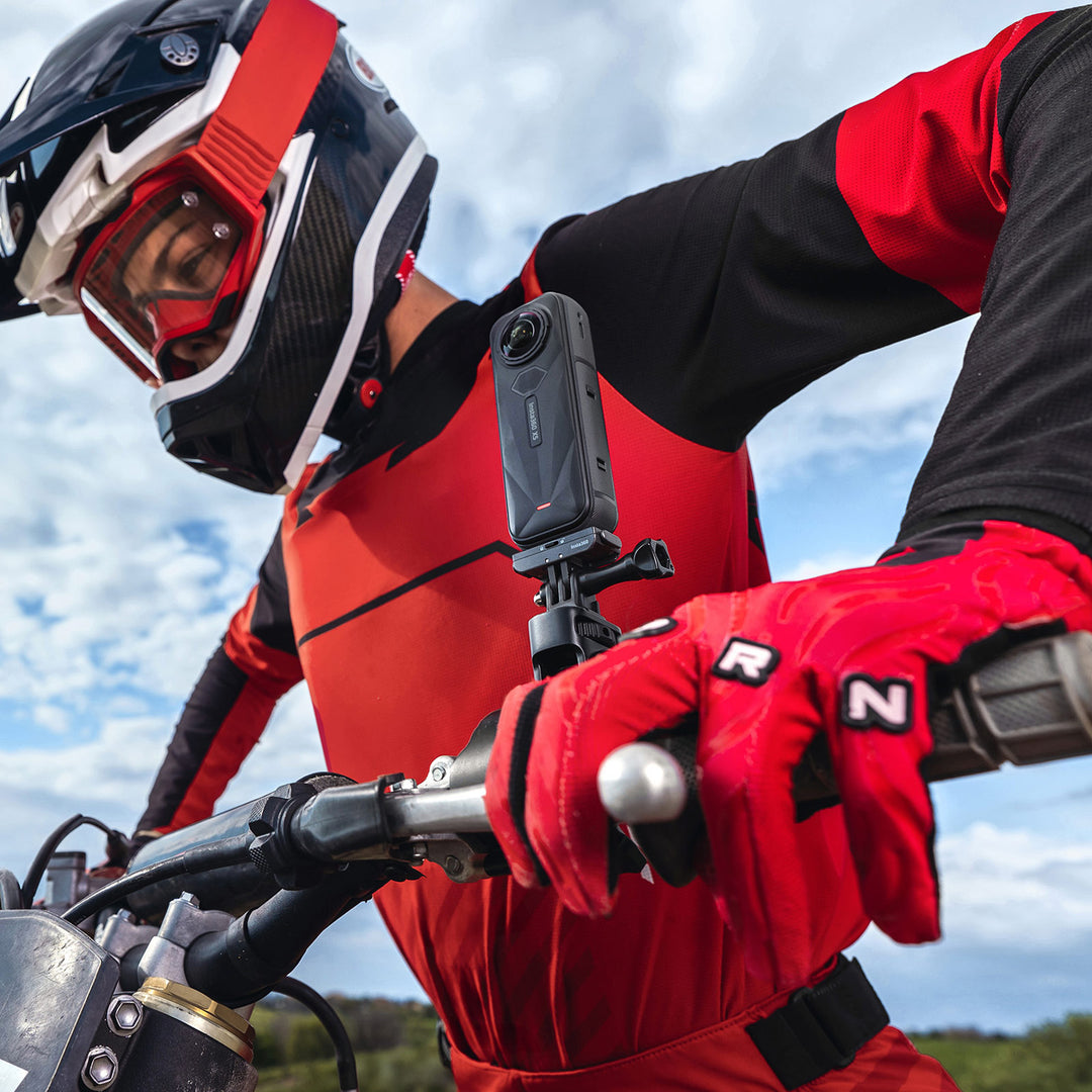 Insta360 X5 Motorcycle Bundle - Lifestyle Close-Up of Dirt Bike Rider Leaning Over Handlebars with X5 Camera Attached Next to Grip
