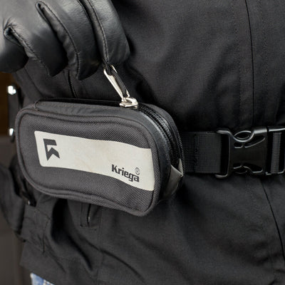 Kriega Harness Pocket - Close-Up of Model Unzipping Pocket on Waist Band