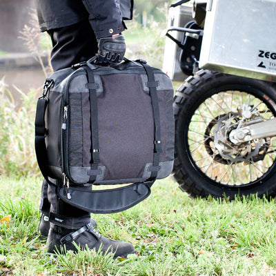 Kriega KS40 Travel Bag - Lifestyle Close-Up of Rider Carrying Back by Hand Handle