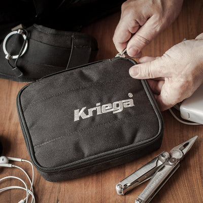 Kriega Kube Organizer - Lifestyle Close-Up of Model Unzipping Organizer