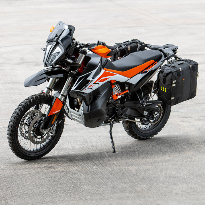 Kriega OS-32 Soft Pannier - Lifestyle of Pannier Installed on Parked Orange Dual Sport Motorcycle