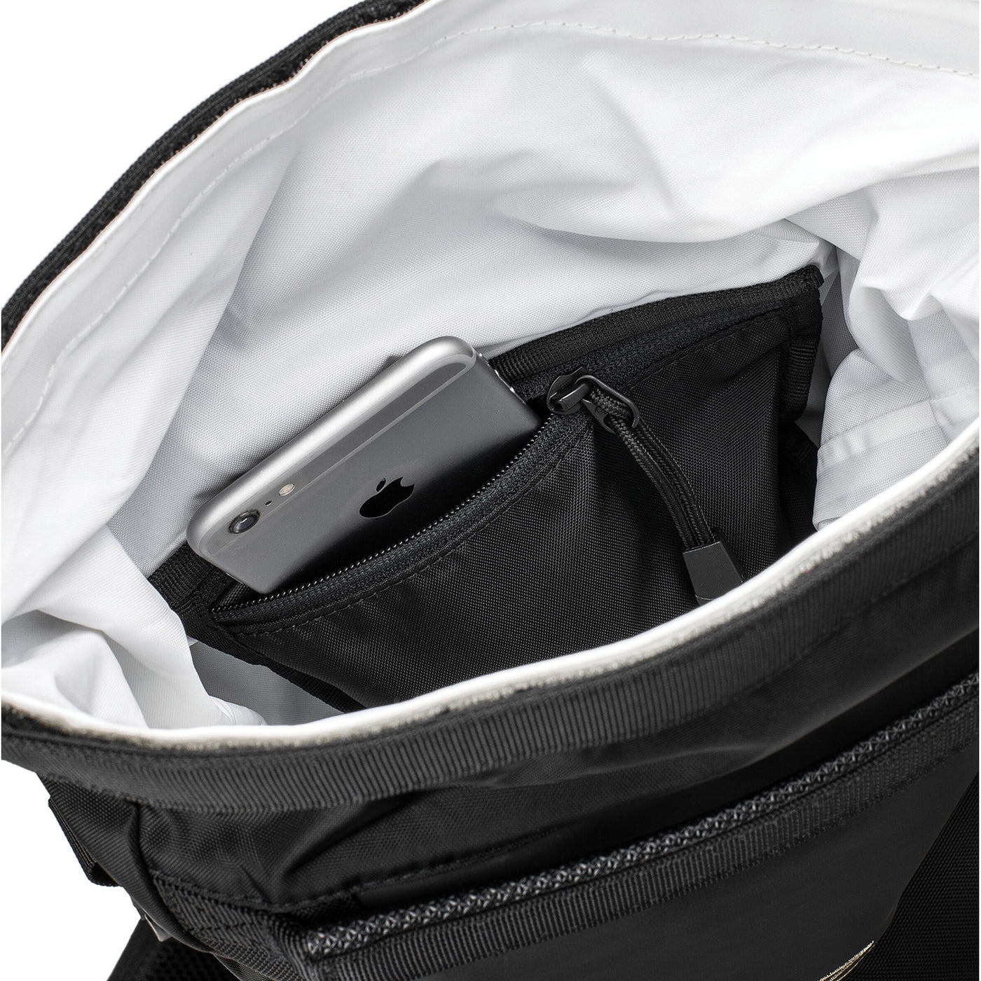 Kriega R16 Backpack - Close-Up of Opened Top with Phone Sticking out of Interior Zippered Pocket