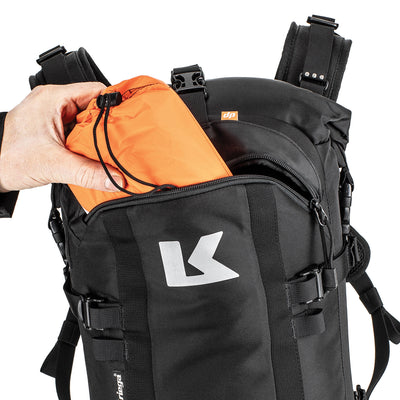 Kriega R22 Backpack - Close-Up of Model Pulling Bag out of Front Zippered Section