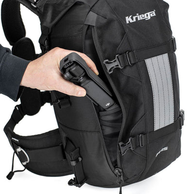 Kriega R25 V2 Backpack - Lifestyle Shot of Hand placing Tools inside Backpack