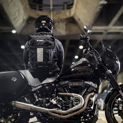 Kriega R25 V2 Backpack - Lifestyle Shot of rider sitting on motorcycle while wearing backpack