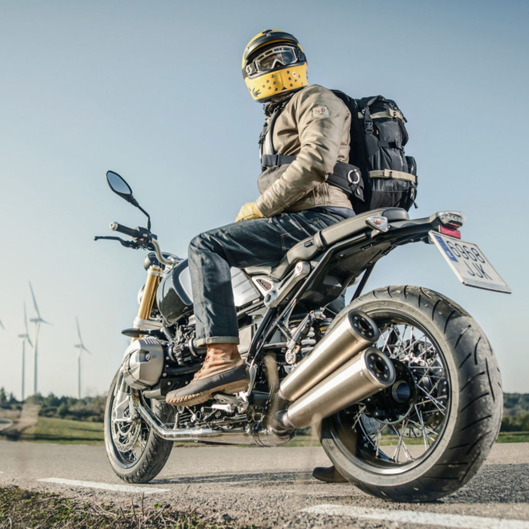 Kriega R30 Backpack - Lifestyle of Rider Wearing Backpack While Looking Back on Motorcycle