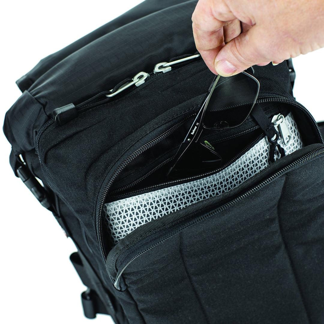 Kriega Sling Pro Messenger Bag - Close-Up of Model Pulling Sun Glasses Out of Zippered Pocket in Mid Section