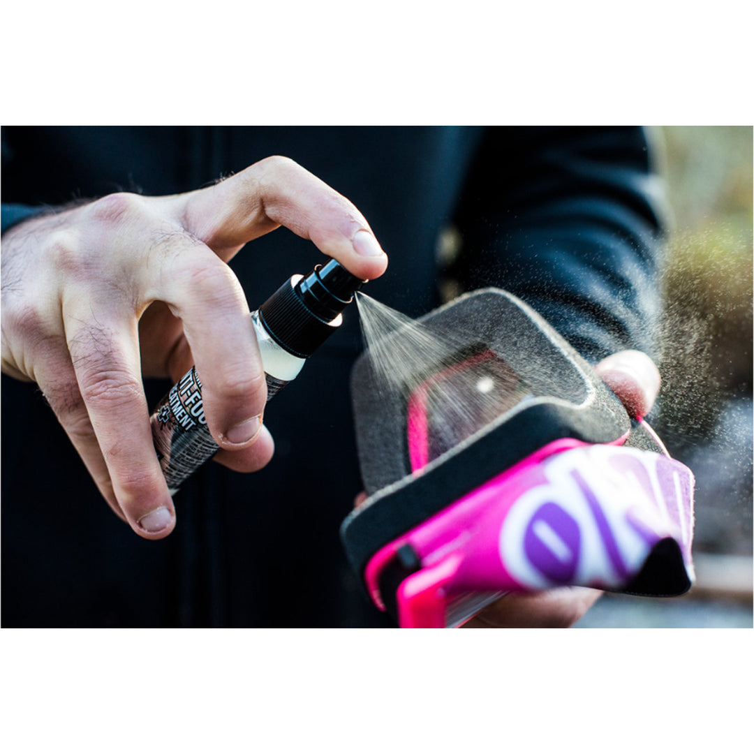 Muc-Off Anti-Fog Treatment - 32ml - Lifestyle Close-Up of Model Spraying Treatment on Goggle Lens