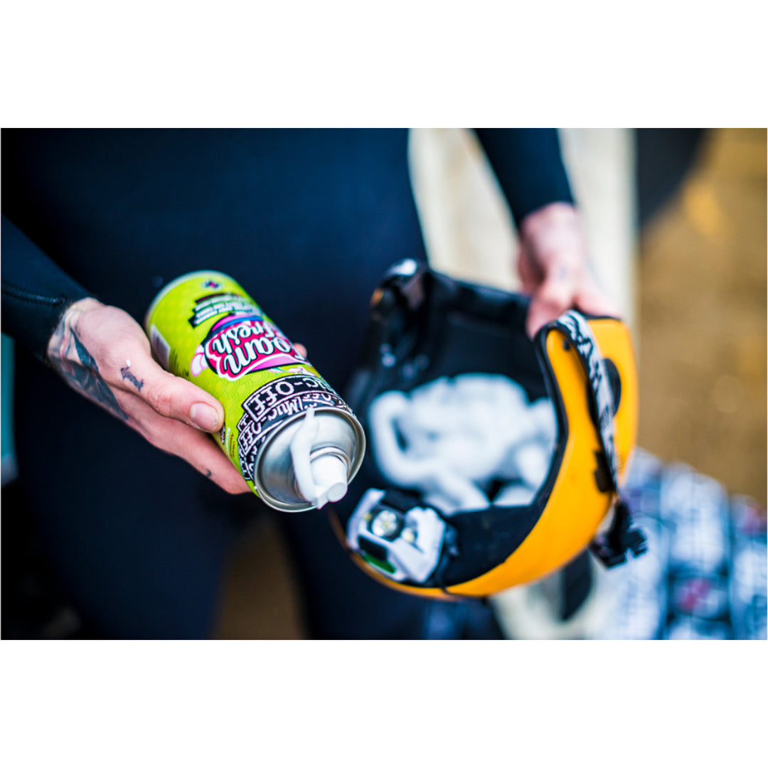 Muc-Off Foam Fresh - 400ml - Lifestyle Close-Up of Model Spraying Foam Fresh into Yellow Helmet