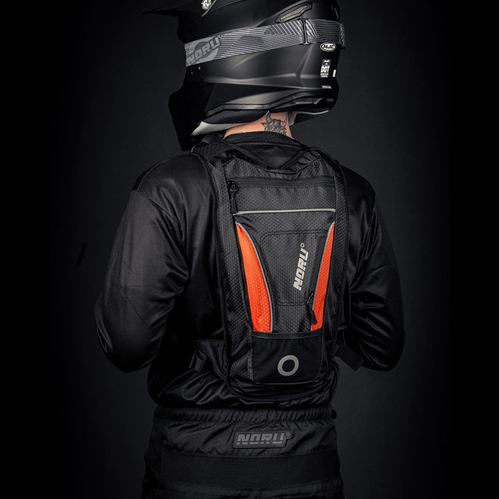Noru Hidaka Hydropack Black/Orange - Angled View from Back of Model Wearing Hydropack