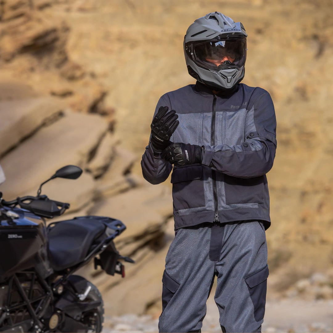 Noru Hakken Adventure Mesh Pants Grey - Lifestyle of Rider Wearing Pants while Pulling On Gloves