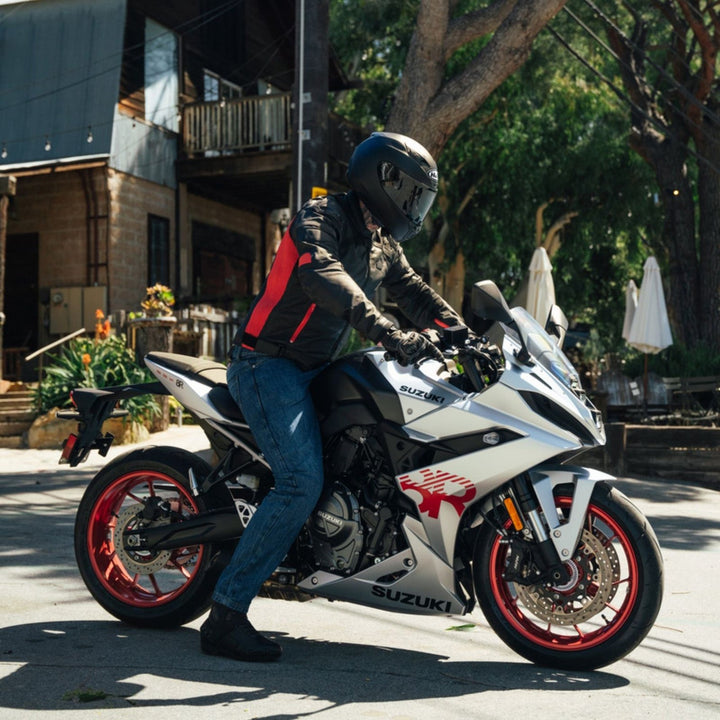 Noru Kaneda Leather Jacket Black/Red - Lifestyle Shot of Rider on White Sport Motorcycle Wearing Jacket
