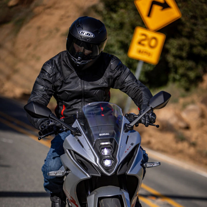 Noru Kaneda Leather Jacket Black/Red - Lifestyle of Rider Wearing Jacket while Riding Silver Sport Motorcycle