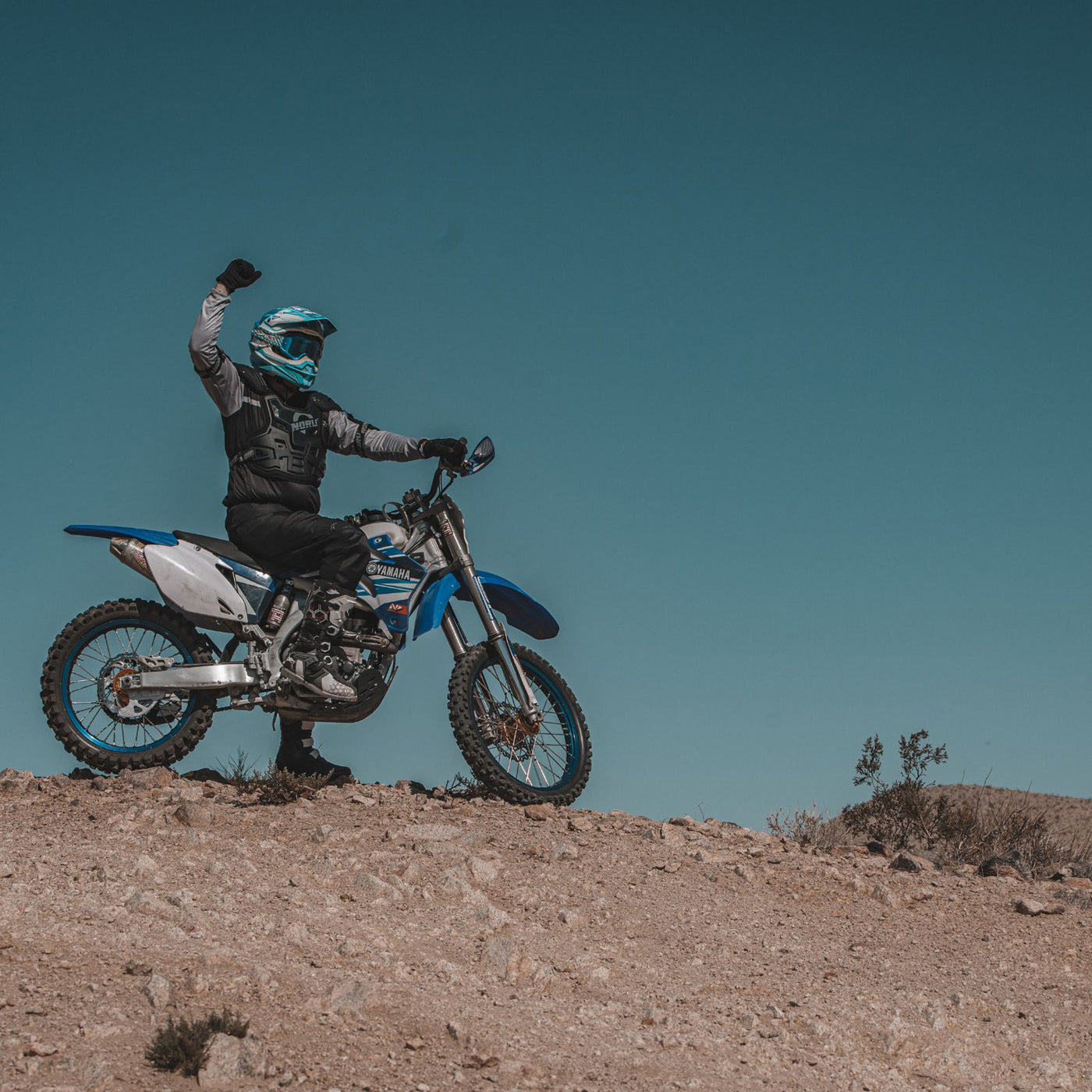 Noru Mamoru MX Roost Guard - Lifestyle of Rider on Top of Dirt Hill Wearing Roost Guard