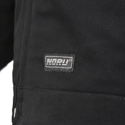 Noru Spanner Jacket Black - Close-Up of Brand Logo Tag on Lower Front