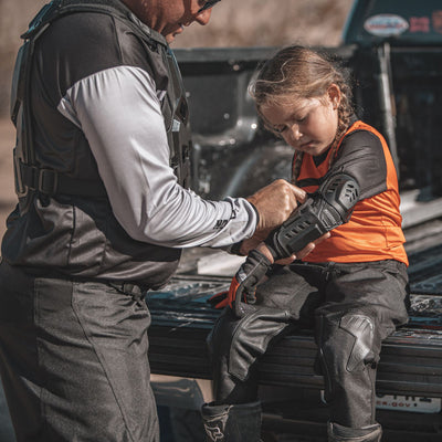 Noru Youth Mamoru Elbow Guards - Lifestyle of Youth Rider Getting Help Putting on Elbow Guards