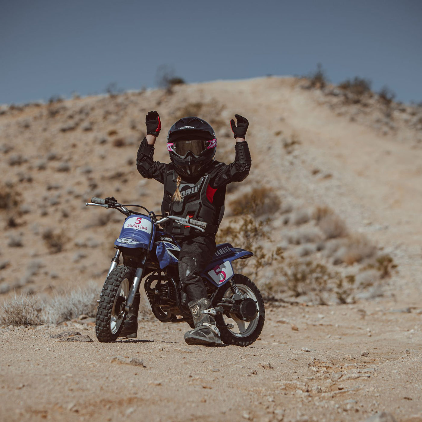 Noru Youth Mamoru Elbow Guards - Lifestyle of Youth Rider wearing Elbow Guards on Blue Dirt Bike