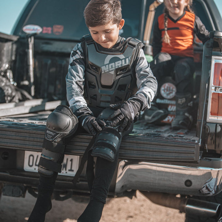 Noru Youth Mamoru Knee/Shin Guards - Lifestyle of Youth Putting on Knee Guard