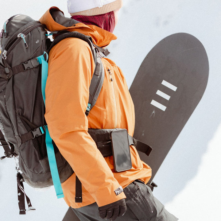 Quad Lock Belt/Utility Clip (V3) - Lifestyle of Snow Boarder with Phone on Utility Clip Attached to Backpack Waist Strap