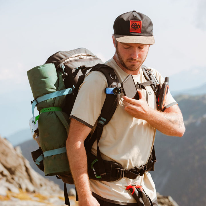 Quad Lock Belt/Utility Clip (V3) - Lifestyle of Hiker Attaching Phone to Utility Clip on Shoulder Strap