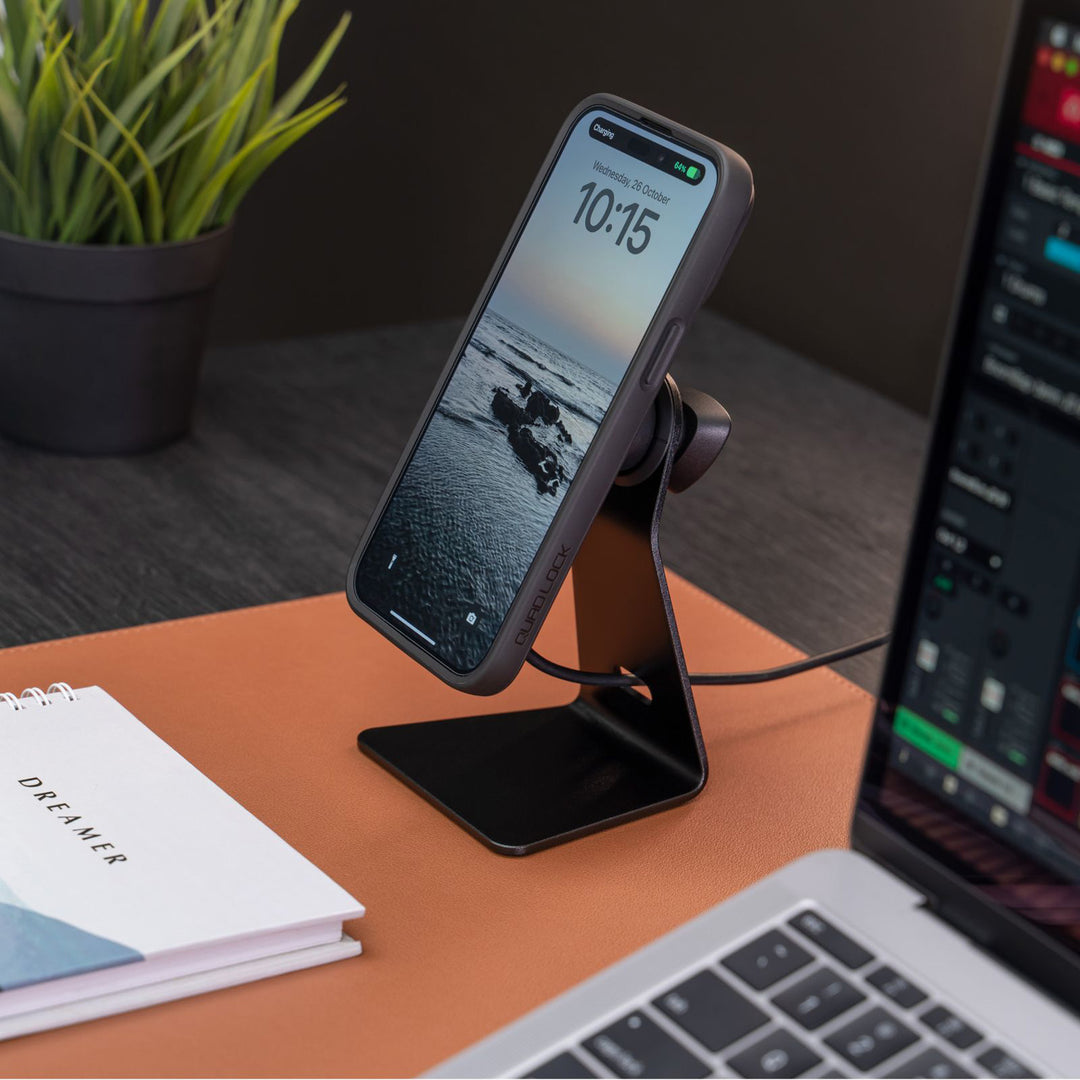 Quad Lock Desk Mount - V2 - Lifestyle of Desk Mount on Desk with Phone Attached and Plugged into Charge