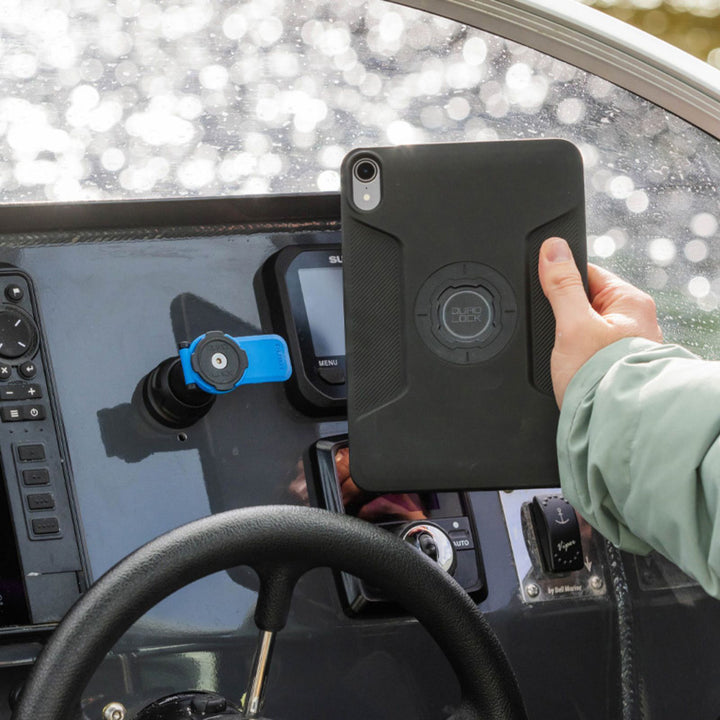 Quad Lock iPad Case - iPad Mini 6 MAG - Lifestyle of Driver Removing iPad from Mount on Boat Dashboard