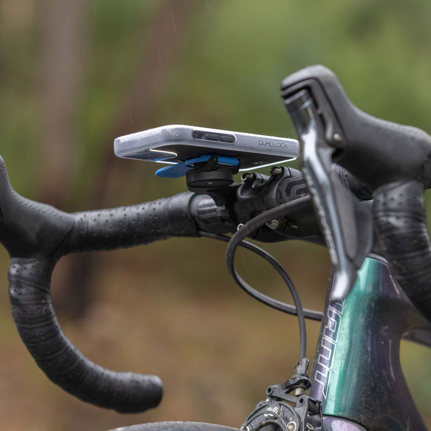 Quad Lock Phone Poncho - iPhone 16 Series - Lifestyle Shot from below Bicycle Handlebar Set-Up