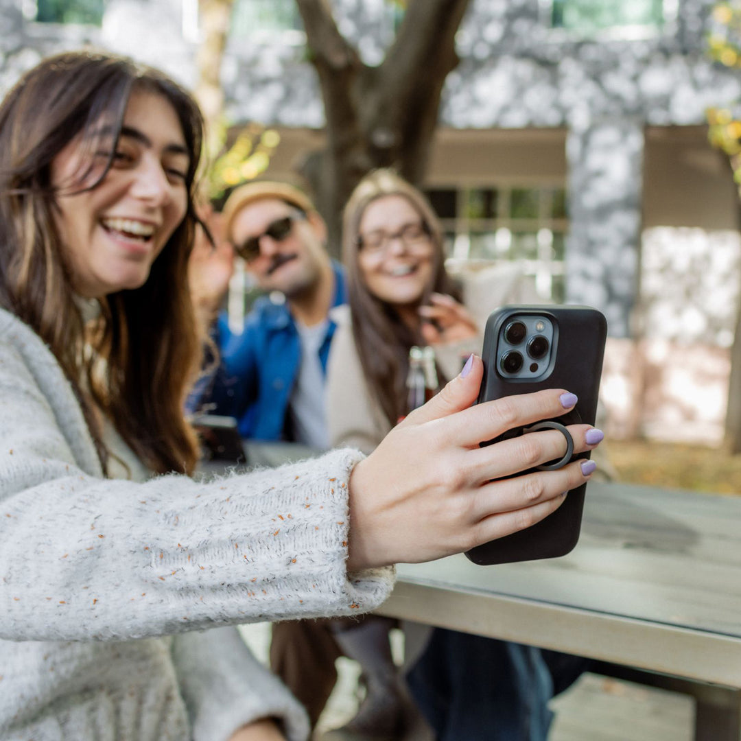 Quad Lock MAG Phone Ring Grip/Stand/Bottle Opener - Lifestyle of User Using Ring Grip to Stabilize Selfie Shot