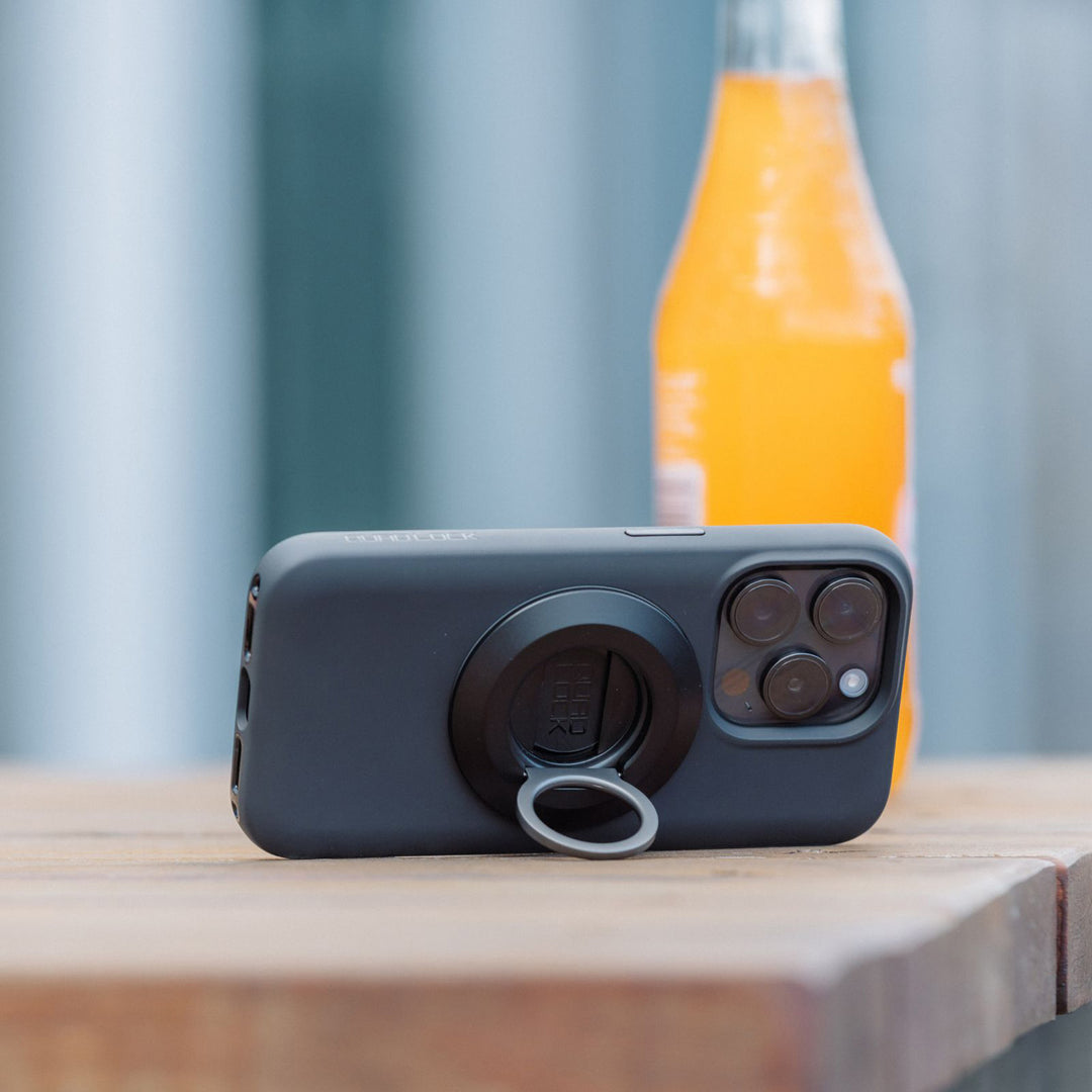 Quad Lock MAG Phone Ring Grip/Stand/Bottle Opener - Lifestyle of Ring Stand Propping up Phone on Table Corner