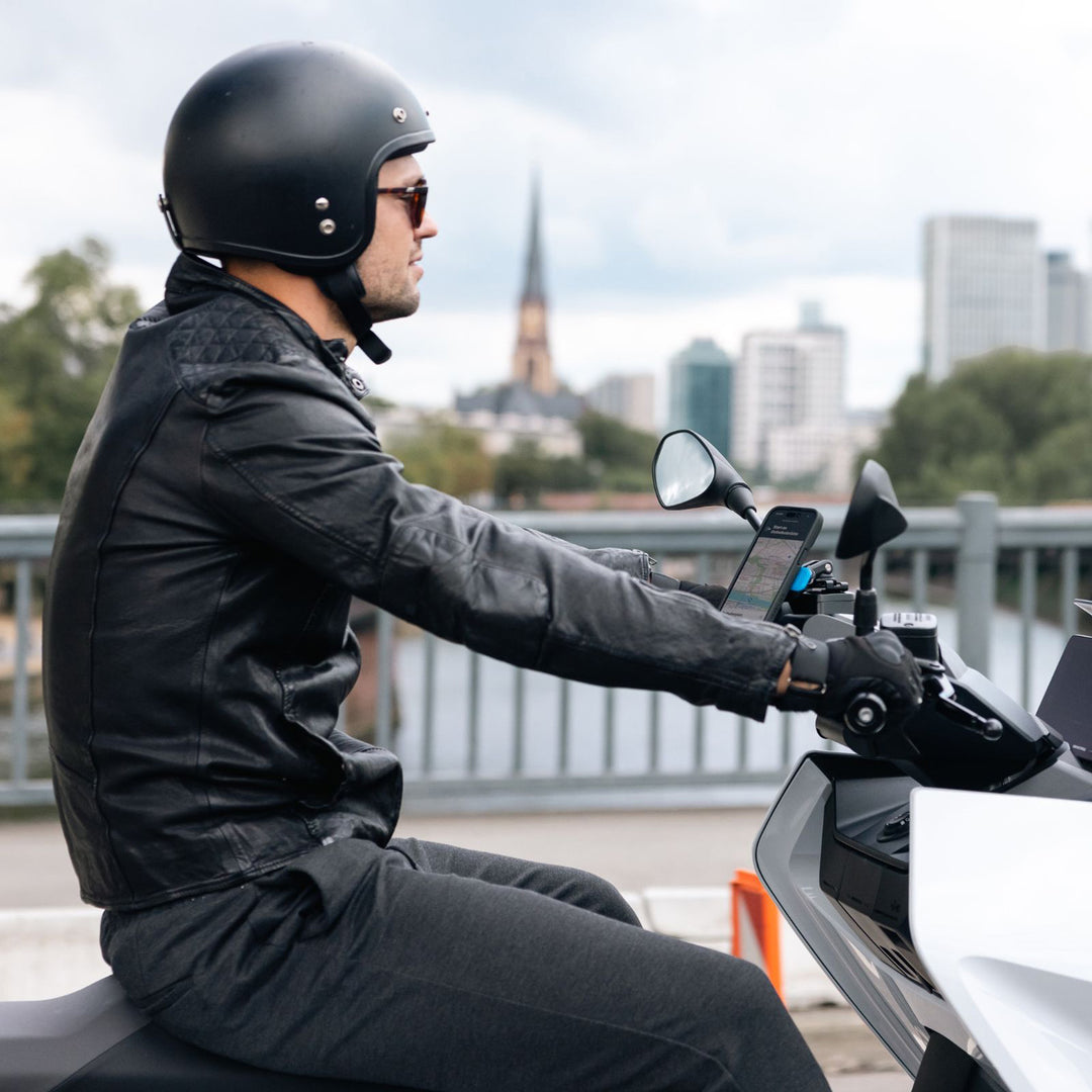 Quad Lock Motorcycle Brake Reservoir Mount (V2) - Lifestyle Angled View of Rider on Silver Motorcycle with Mount Installed