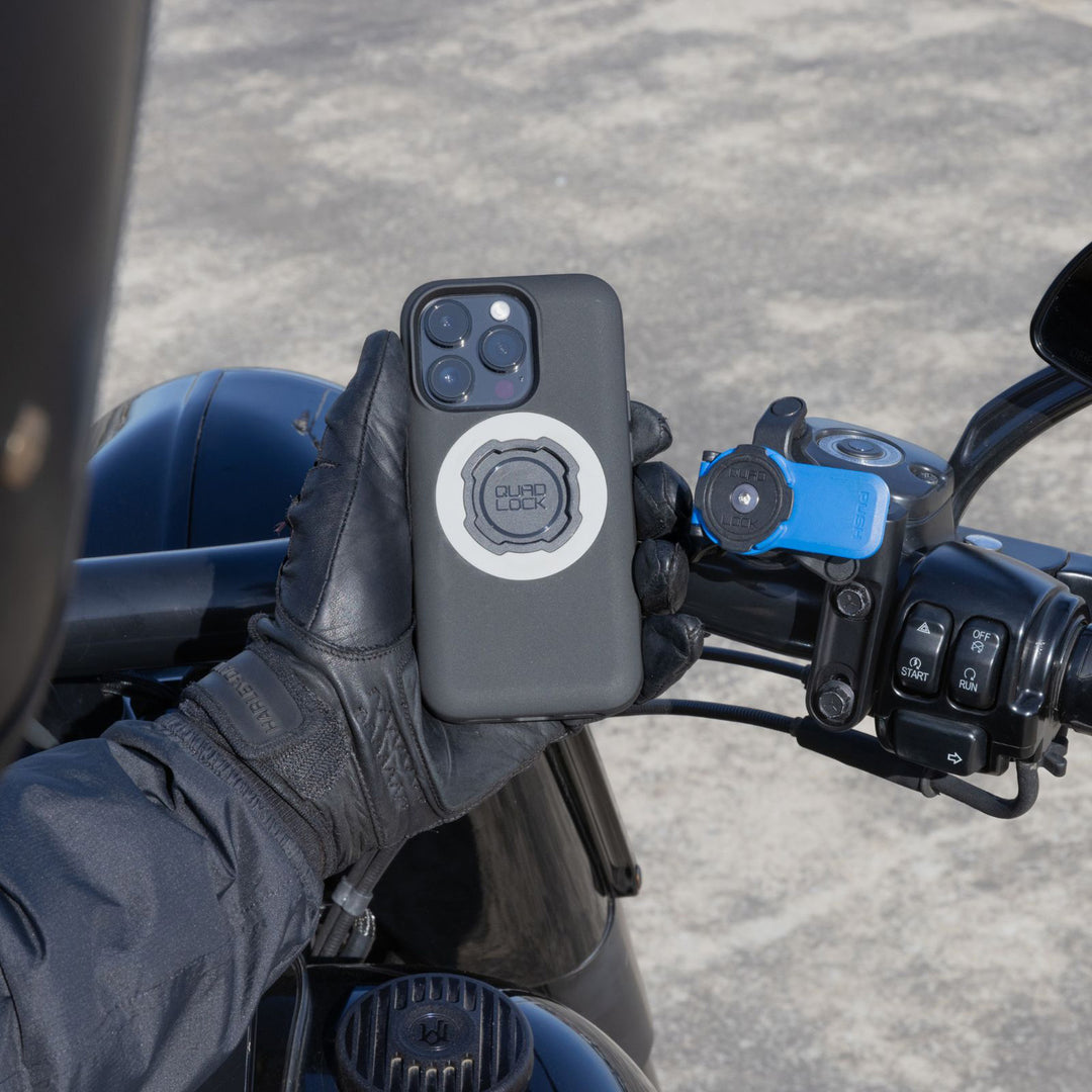 Quad Lock Motorcycle Clutch Mount - Lifestyle of Rider Lining Up Phone Case with Head Lever of Mount