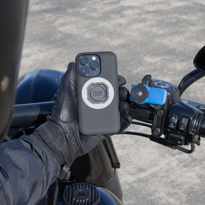 Quad Lock Motorcycle Clutch Mount - Lifestyle of Rider Lining Up Phone Case with Head Lever of Mount