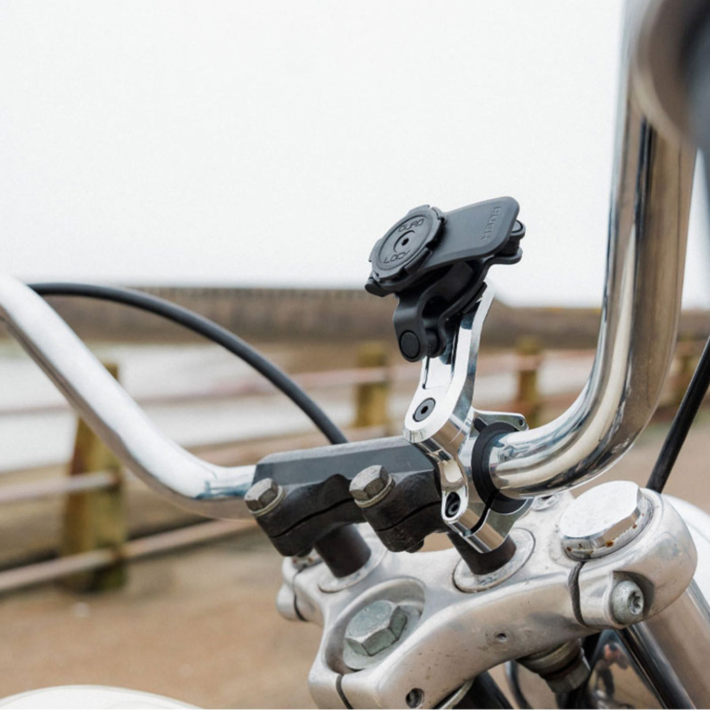 Quad Lock Motorcycle Handlebar Mount Pro - Lifestyle Shot of handlebar mount on motorcycle handlebar