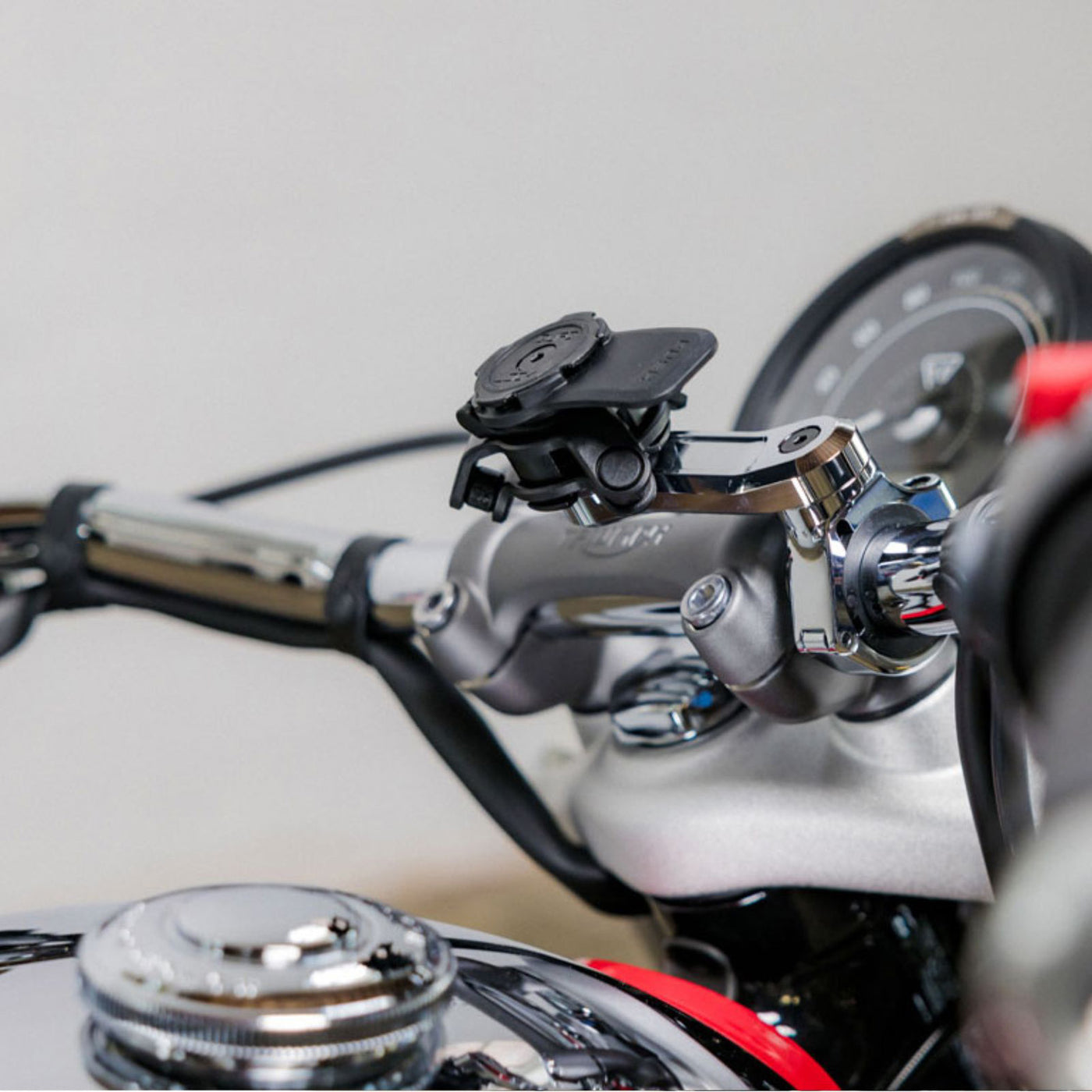 Quad Lock Motorcycle Handlebar Mount Pro - Lifestyle Shot of handlebar mount on motorcycle handlebar